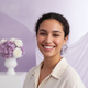 A happy young woman with a genuine smile, a diverse and authentic portrait headshot.